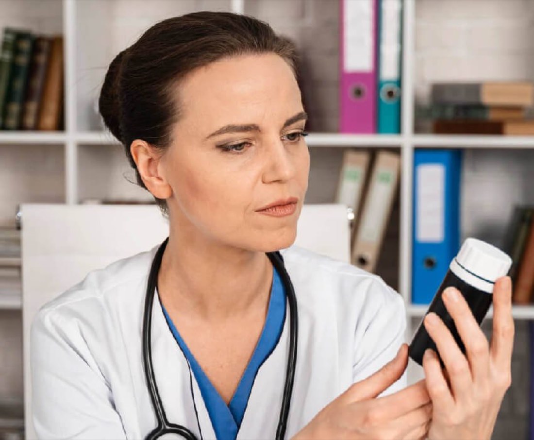 A nurse reviewing a prescription bottle